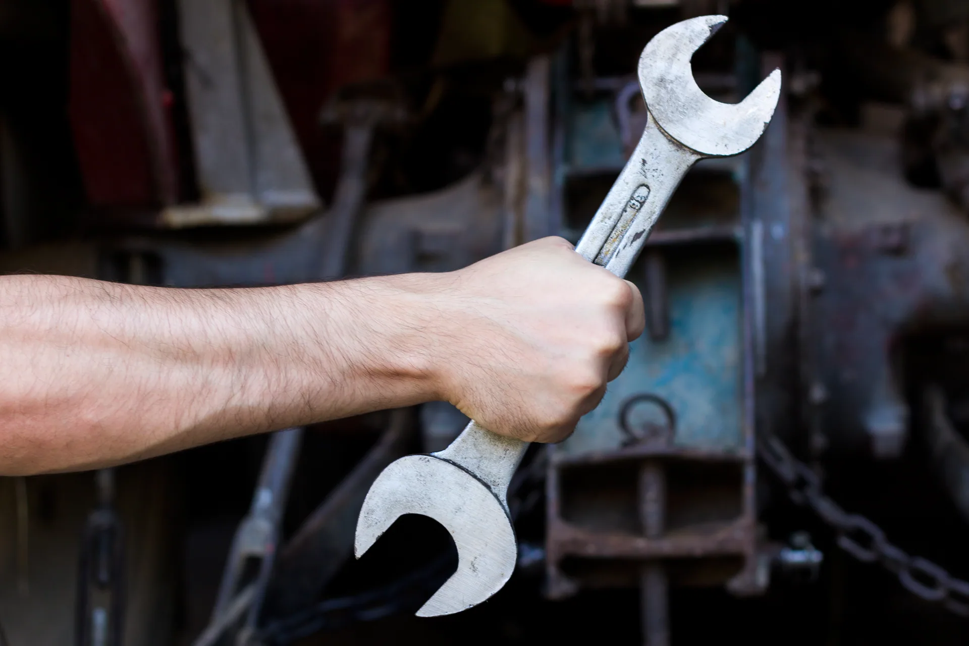Bare hand gripping double open end wrench melrose plumber