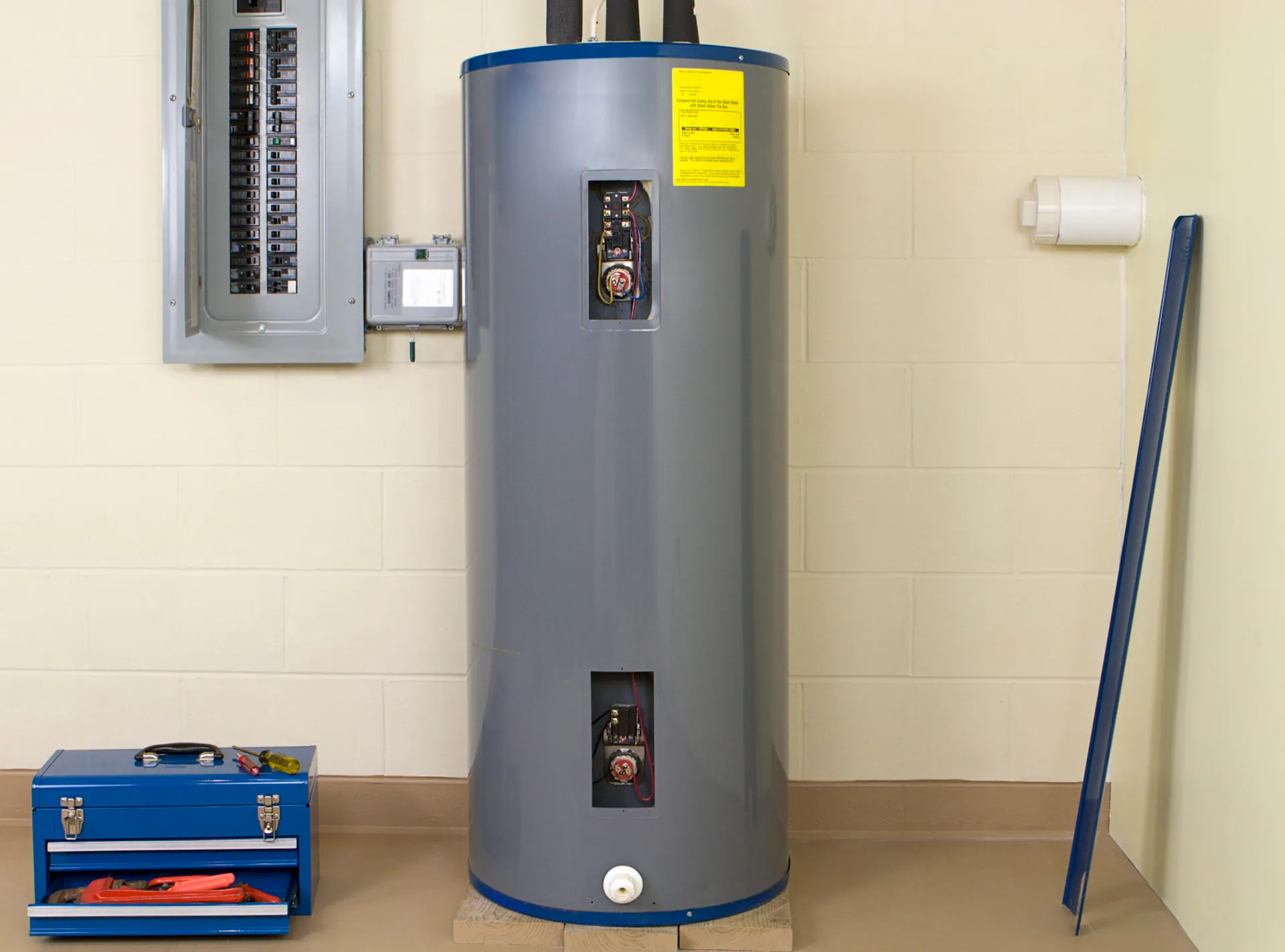 Electric water heater access panels open breaker box blue toolbox basement stone