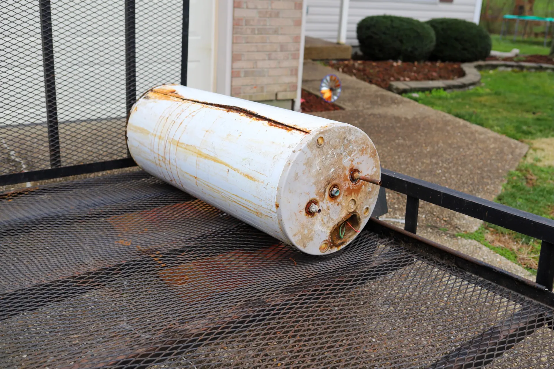 Old rusted water heater tank on utility trailer melrose replacement